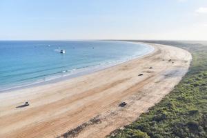 an aerial view of a beach with boats in the water at RAC Cable Beach Holiday Park in Broome