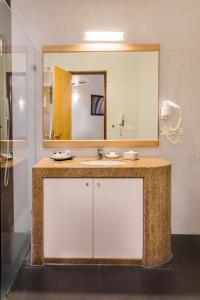 a bathroom with a sink and a mirror at Chances Resort and Casino An Indy Resort in Panaji