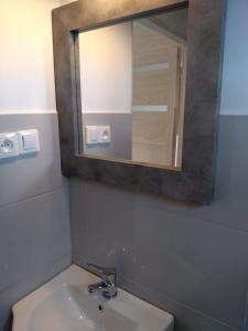 a bathroom with a sink and a mirror at Domki na górce in Kołczewo +30 photos