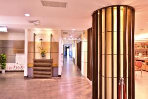 a lobby with a gold column in a building at Toong Mao Resorts & Hotel in Kenting