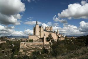 a castle sitting on top of a hill at Hotel Infanta Isabel by Recordis Hotels in Segovia