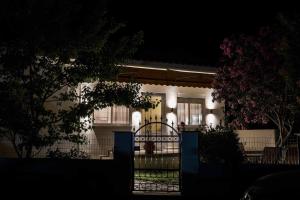 a house with a gate in front of it at night at PHIL HOUSE in Keramoti