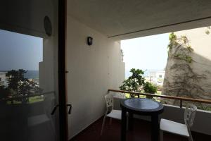 a balcony with a table and chairs and a window at Cimer SafraMarine Beach Resort in Safra