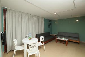 a living room with a couch and a table and chairs at Cimer SafraMarine Beach Resort in Safra