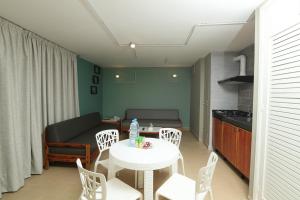 a kitchen and a living room with a table and chairs at Cimer SafraMarine Beach Resort in Safra