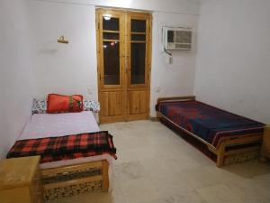 A bed or beds in a room at Adad Noubian House