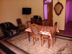 uma sala de estar com uma mesa de jantar e cadeiras em Guest house maka em Gonio