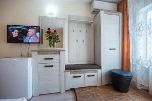 a room with a white cabinet and a tv on the wall at COMPLEX Alutus -Camere de inchiriat in Mangalia