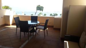 a table and chairs in a balcony with a view of the ocean at 103 - Beach apartment with Spa & Gym in Estepona