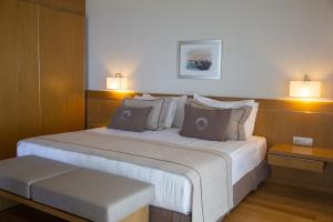 a bedroom with a large white bed with two lamps at ON'LIVE HOTEL in Çeşme