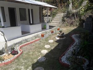 un patio con algunas plantas y una casa en Dahilig Resort, en Puerto Galera