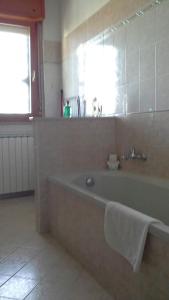 a bathroom with a bath tub with a towel on it at Spazio e tranquillità a Roma in Rome