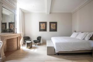 奥德纳尔德Bed & Breakfast Jezuietenplein 21的带白色床和壁炉的卧室