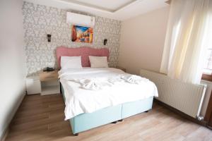 Postel nebo postele na pokoji v ubytování T-Square Residence