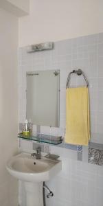 a bathroom with a sink and a mirror at EViF Home Stay in Dhaka
