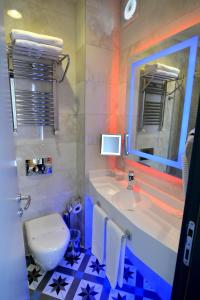 a bathroom with a sink and a toilet and a mirror at Pera Luna Residence in Istanbul +76 photos
