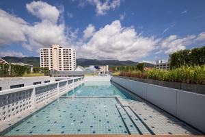 a swimming pool on the roof of a building at Novotel Chiangmai Nimman Journeyhub in Chiang Mai