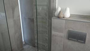 una ducha con puerta de cristal en un baño en Waterside Living CAN05, en Jeffreys Bay 35 fotos más