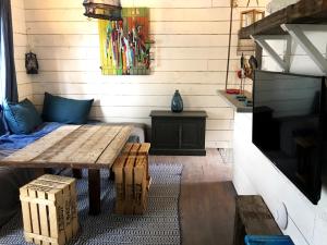 a living room with a wooden table and a couch at Les Maisons de pêcheur avec Jacuzzi in Sète