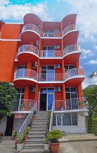 an orange building with stairs in front of it at Hotel Georgia in Gonio