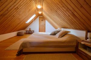 a bedroom with a large bed in a attic at Beautiful cottage with heated pool for 22 ppl in Plaški