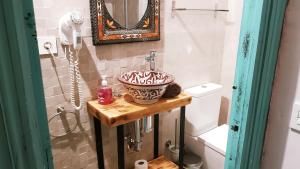a bathroom with a sink and a mirror at Riad Puertas del Albaicín in Granada +77 photos