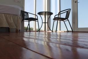 two chairs and a table in a room with a bed at Holssel road 864 in Myvatn