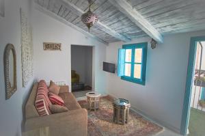 a living room with a couch and a window at Riad Puertas del Albaicín in Granada