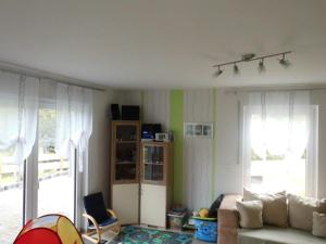 sala de estar con sofá y 2 ventanas en Gästehaus Querenhorst, en Querenhorst