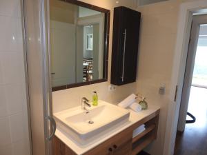a bathroom with a sink and a mirror at Apartment Barbara in Mutters