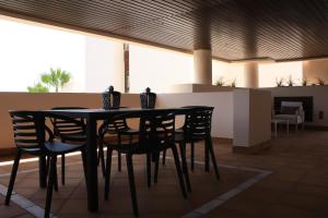 a black table and chairs in a room at 104 - Apartment with private swimming pool in Estepona