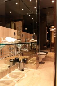 a bathroom with a toilet and a glass counter at 104 - Apartment with private swimming pool in Estepona