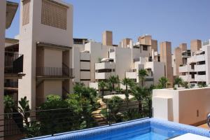 a view from the balcony of a building with a swimming pool at 104 - Apartment with private swimming pool in Estepona