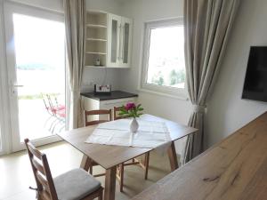 a dining room table with a vase of flowers on it at Apartment Barbara in Mutters +8 photos