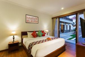 a bedroom with a large bed and a sliding glass door at Villa Sabasanti Gianyar in Keramas +55 photos