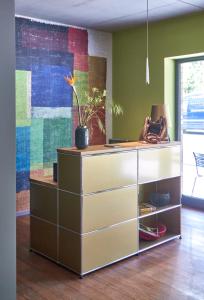 a dresser with a potted plant on top of it at Just Eleven in Sankt Peter-Ording