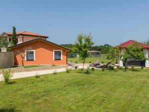 a house in a field with a yard at Attractive Holiday Home with Pool bubble bath Patio Courtyard in Barbariga