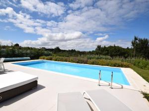 una piscina en un patio con sillas en Comfortable villa with private pool in Nadadouro, en Nadadouro