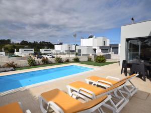 a villa with a swimming pool and lounge chairs at Lavish Villa in Foz do Arelho with Private Pool in Foz do Arelho