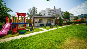 a playground with a slide in a yard at Vila Argentinia (Aria Betul) in Saturn