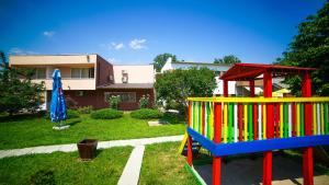 a playground in a yard next to a house at Vila Argentinia (Aria Betul) in Saturn