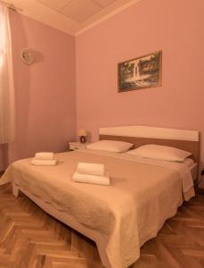 a bedroom with a bed with towels on it at Hotel Park Drniš in Drniš