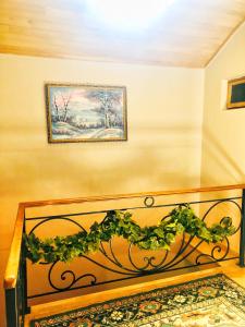 a bed in a room with a picture on the wall at hotel Pharnavaz in Batumi