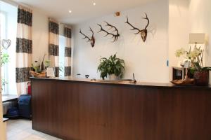 a hotel reception desk with antlers on the wall at Hotel am Viktualienmarkt in Munich