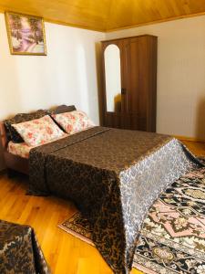 a bedroom with a bed and a couch at hotel Pharnavaz in Batumi