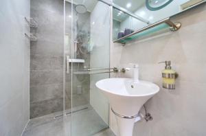 a bathroom with a sink and a shower at Apartments Stolfa in Krk