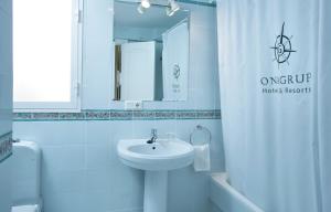 a white bathroom with a sink and a mirror at Ona Campanario in La Cala de Mijas