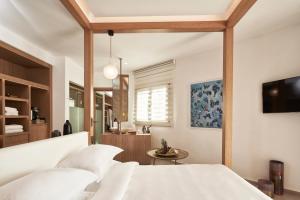 A bed or beds in a room at Myconian Naia - Preferred Hotels & Resorts
