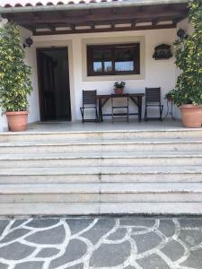 a patio with a table and chairs on a house at Stavroula's House in Skiathos