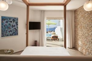 A bed or beds in a room at Myconian Naia - Preferred Hotels & Resorts